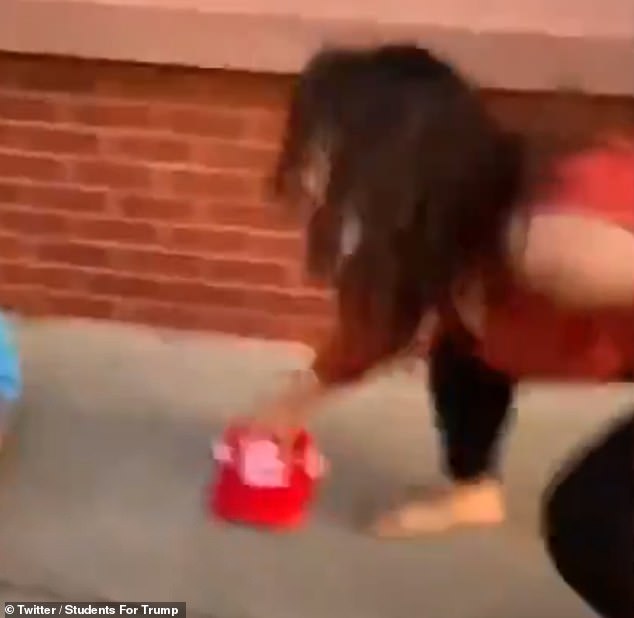 The footage begins with one woman kicking a sign along the ground and the woman filming saying 