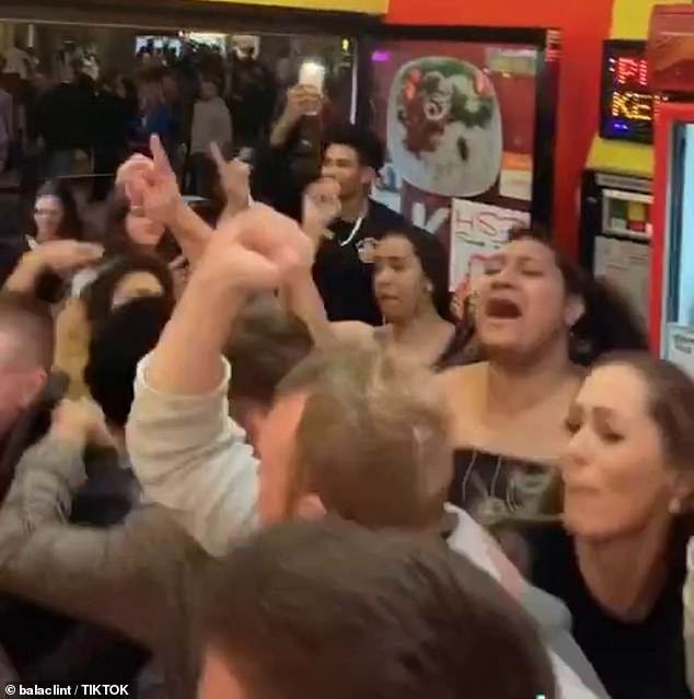 An employee of Shah Kebabs said the large crowd descended on the shop after all the nearby nightclubs closed (revellers pictured in Shah Kebabs in Brisbane)
