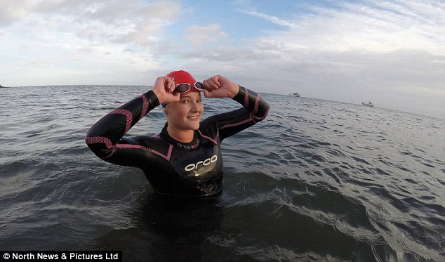 All smiles: Wild swimmer Kate Lawson, who believes outdoor swimming helps keep you physically fit and mentally healthy - pictured at Boulmer Bay on the Northumberland coastline