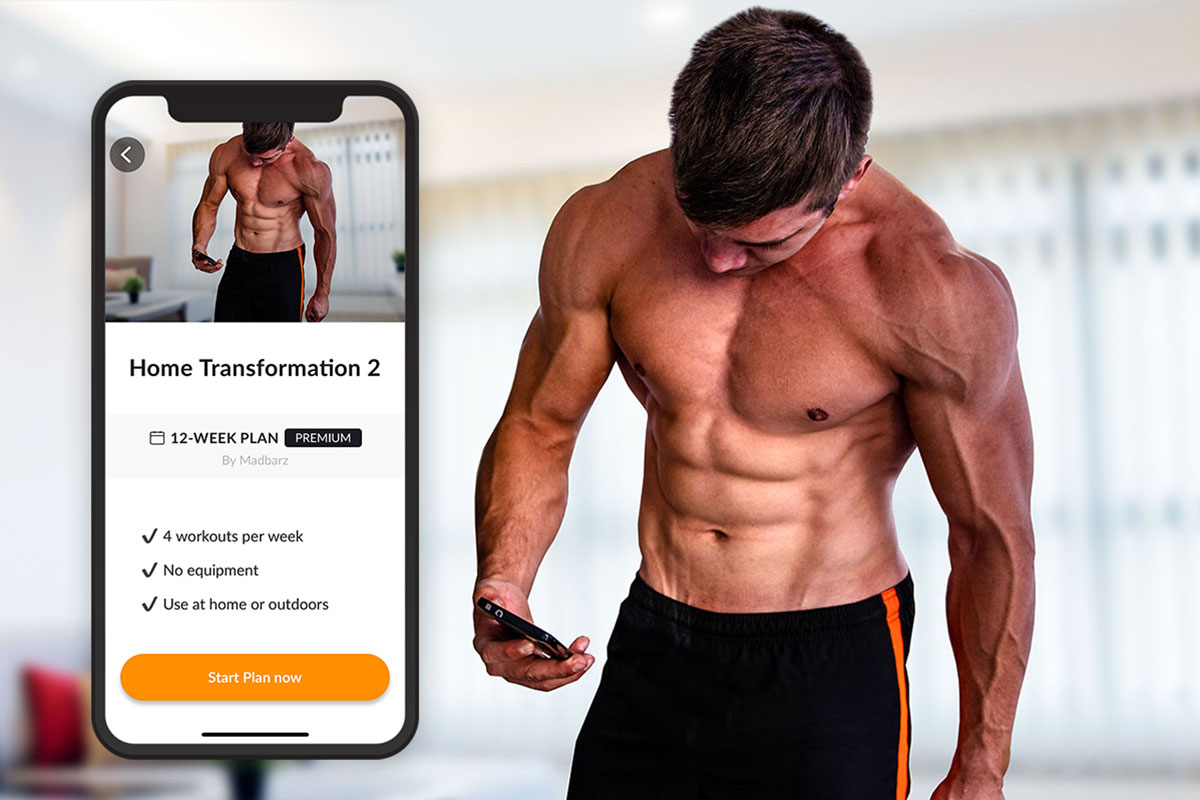 On the right half of the picture, there is a ripped man, wearing training shorts, shot only sows him up to the middle of his tights. On the left side of the picture, there is a screenshot of the phone scren, showing the Madbarz Home Transformation 2 workout plan homepage, featuring the same photo of the man on the right side. Below the photo, there is a title 