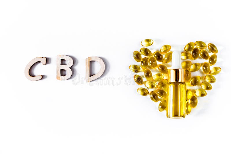 Assorted medical cannabis products  capsules and CBD oil isolated over white background. Heart shaped capsules and bottle royalty free stock photo