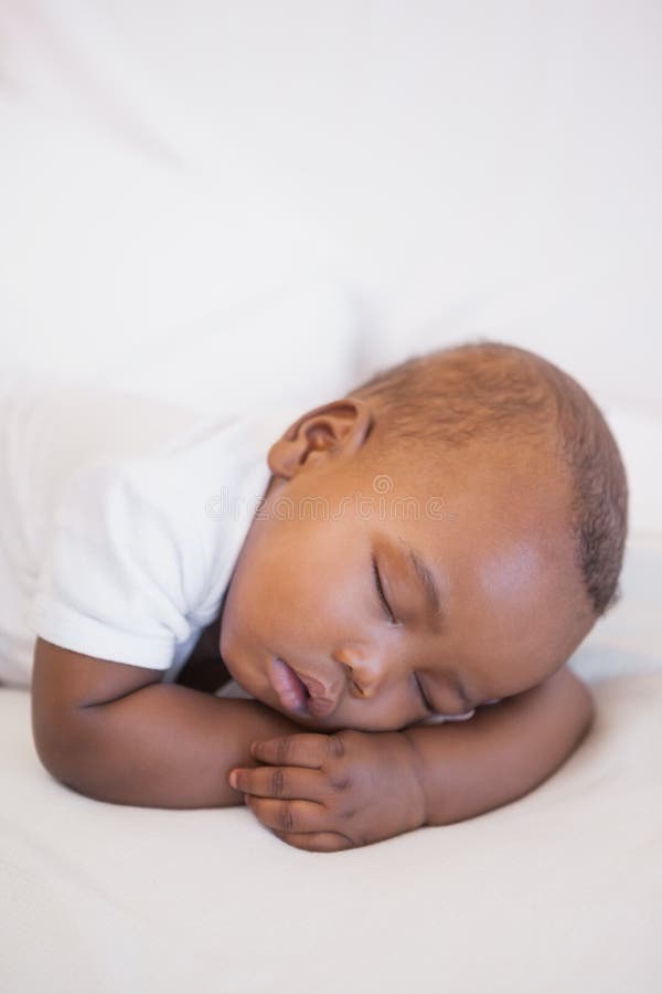 Baby boy sleeping peacefully on couch stock images