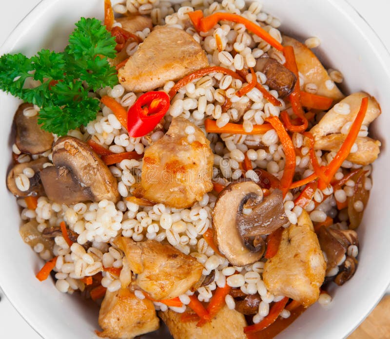 Barley porridge with, meat, mushrooms and carrots. Close up of Barley porridge with, meat, mushrooms and carrots stock image