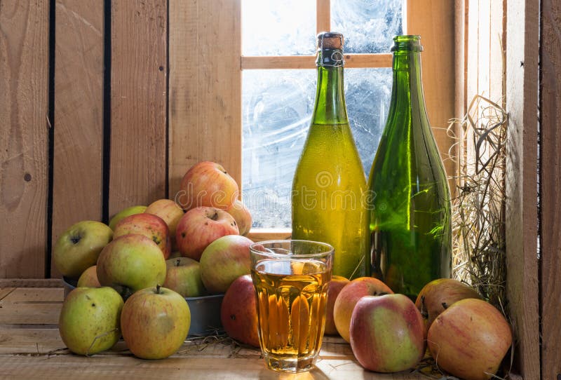 Bottles and glass of cider with apples stock photo