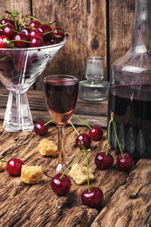 Cherry alcohol drink. Homemade alcohol tincture from summer cherry berries stock image