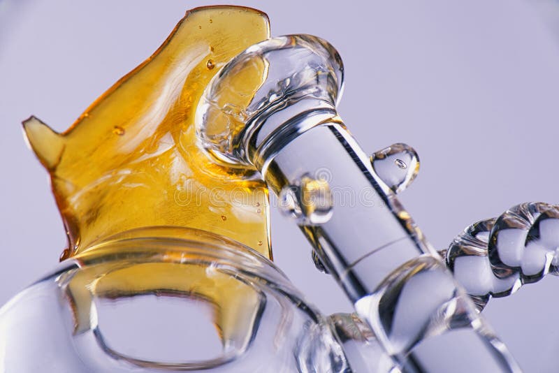 Close up view of a piece of cannabis oil concentrate aka shatter stock image