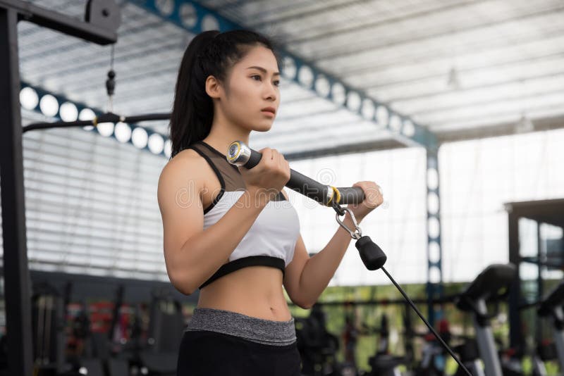 Closeup of a young fitness asian woman workout at sport club stock image