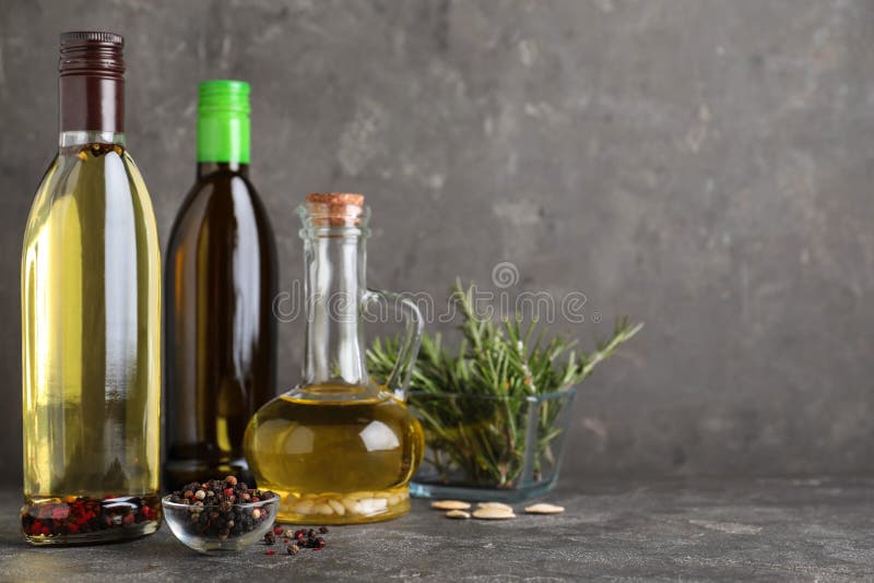 Composition with different sorts of cooking oil on grey table. Space for text stock photos