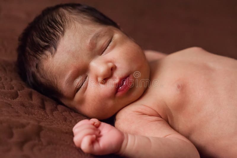 Cute two weeks old newborn baby girl without clothes, naked or nude, sleeping stock photography