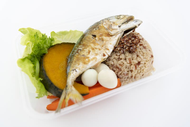 Deep fried mackerel with rice and boiled vegetables in a box. Isolate in white stock image