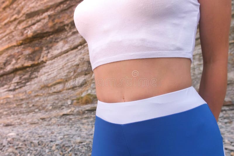 Flat belly girl during breathing exercises bodyflex. Belly close-up view. Flat belly girl during breathing exercises body flex royalty free stock image
