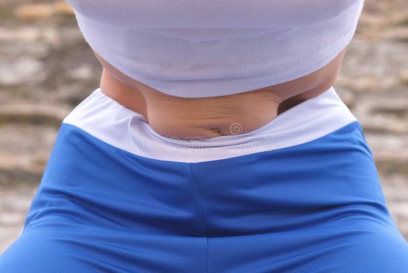 Flat belly girl during diaphragmatic breathing exercises bodyflex on the rock background. Belly close-up view. Flat belly girl during diaphragmatic breathing royalty free stock photos
