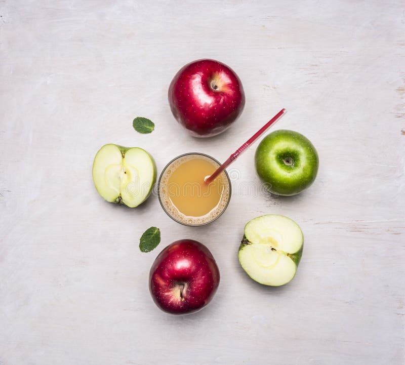 Freshly squeezed apple juice from different varieties of apples wooden rustic background top view close up stock image