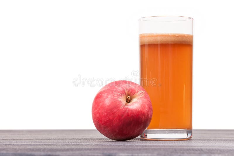 Freshly squeezed apple juice in the glass on table isolated royalty free stock images