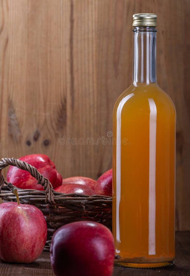 Freshly squeezed apple juice with natural pulp. Red apples for juice royalty free stock image