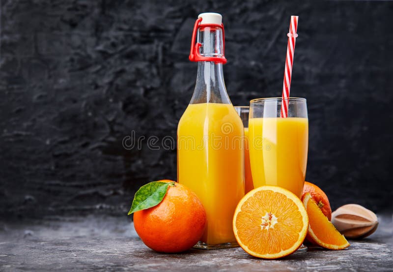 Freshly squeezed orange juice in glass bottle stock photography