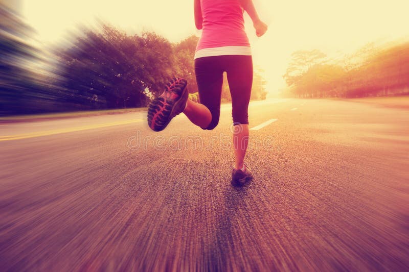Healthy lifestyle fitness sports woman running leg. Healthy lifestyle fitness sports woman legs running at sunrise road royalty free stock photography