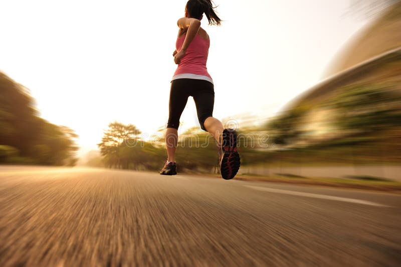 Healthy lifestyle fitness sports woman running leg. Healthy lifestyle fitness sports woman legs running at sunrise road stock photography