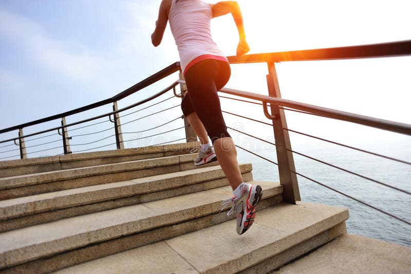 Healthy lifestyle woman legs running on stone stai. Healthy lifestyle sports woman legs running on stone stairs seaside stock photo