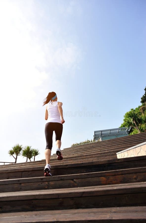Healthy lifestyle woman legs running on wooden sta. Healthy lifestyle sports woman legs running on wooden stairs seaside royalty free stock photo