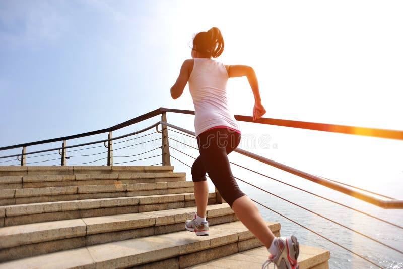 Healthy lifestyle woman legs running on stone stai. Healthy lifestyle sports woman legs running on stone stairs seaside royalty free stock photography
