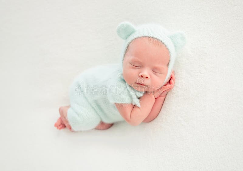 Newborn baby sleeping in mint clothes royalty free stock image
