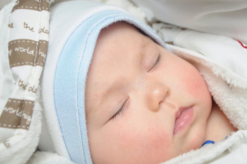 Newborn baby sleeping in clothes royalty free stock image