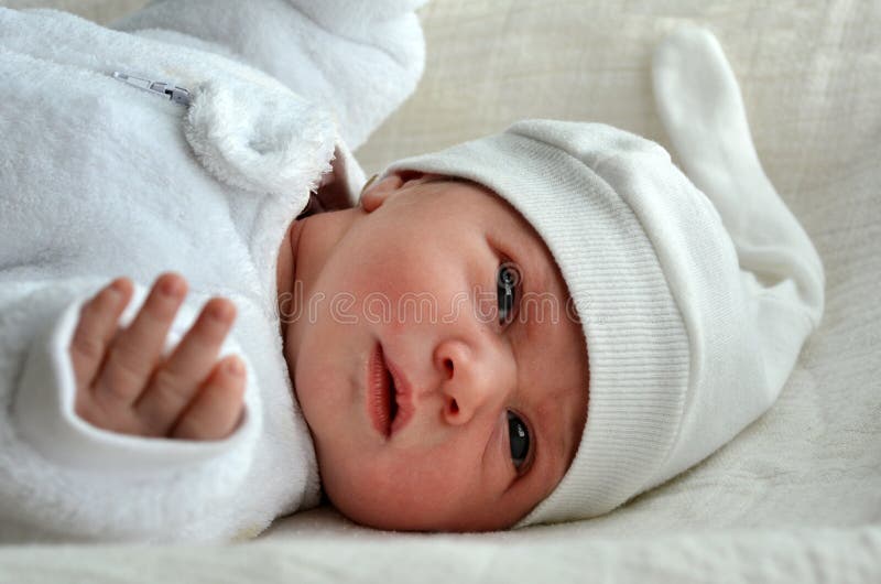 Newborn baby with warm clothes stock images