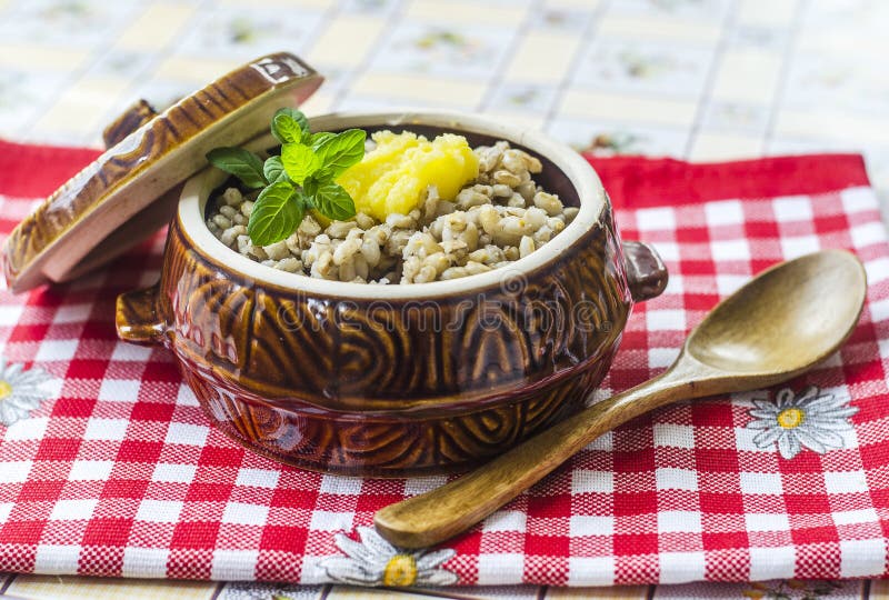 Pearl barley porridge. With butter in ceramic bowl stock photos