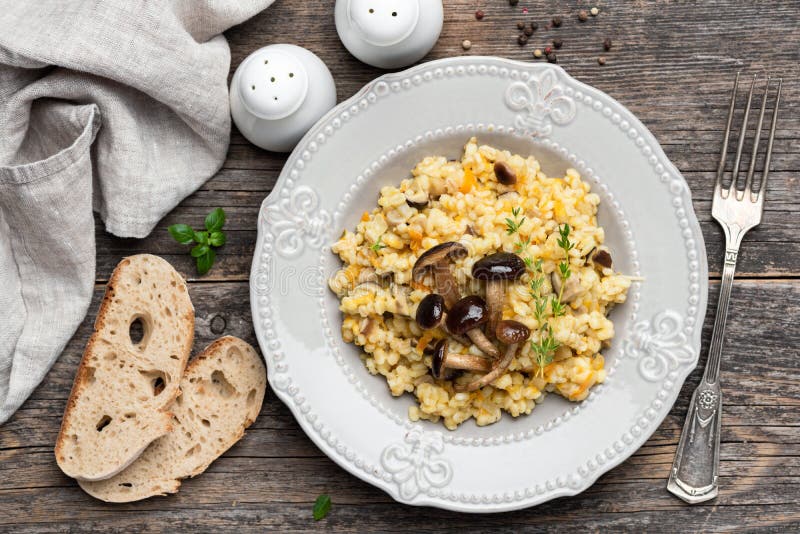 Pearl barley risotto with mushrooms stock images