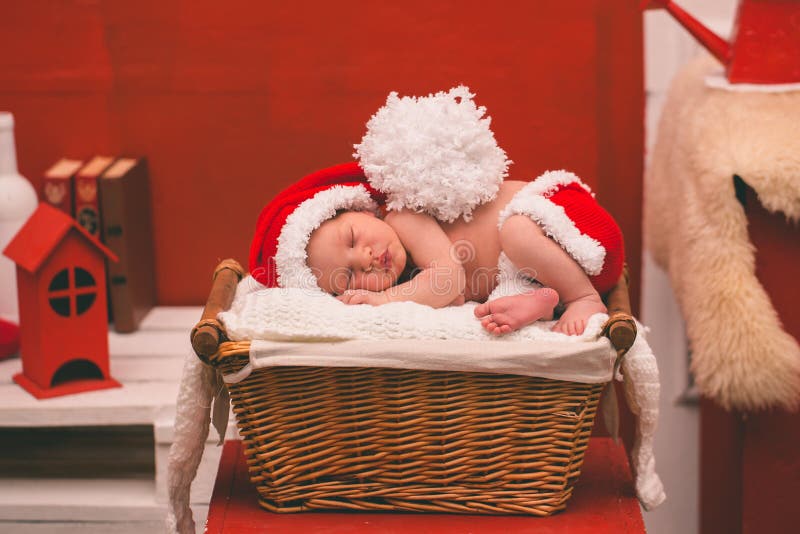 Portrait of sleeping newborn baby boy in Santa clothes. royalty free stock images