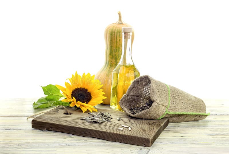 Sunflower seeds and sunflower oil on a white background royalty free stock image