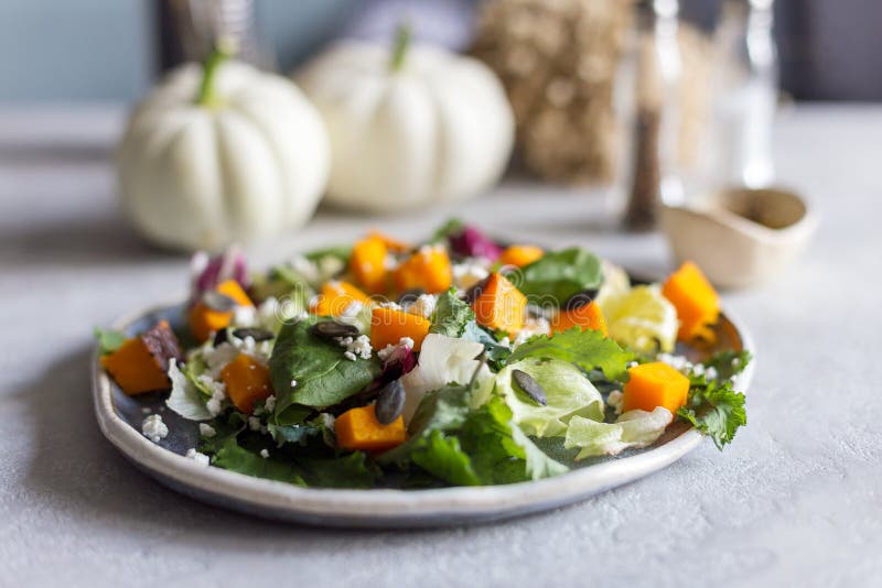 Salad with pumpkin and cheese on plate stock photos