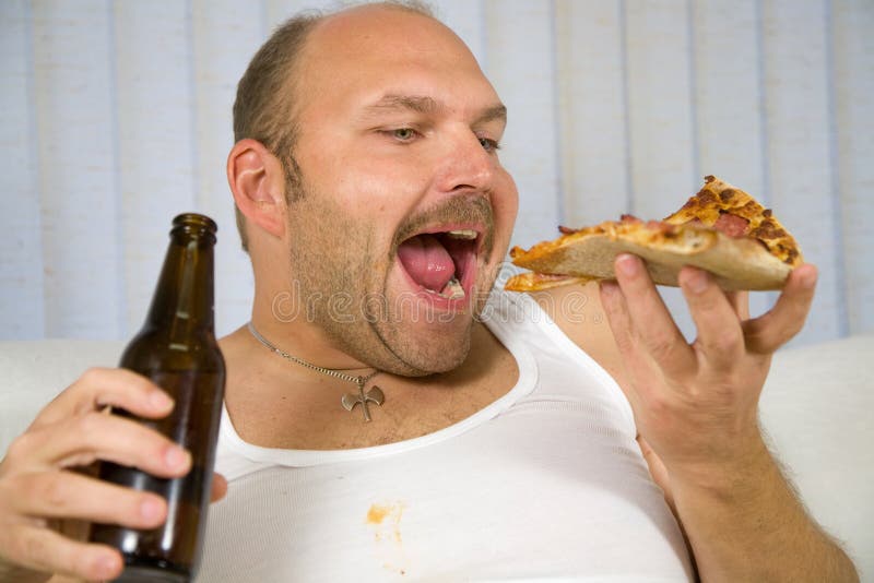 Unhealthy behaviour. Overweight mature man with pizza in one hand and a beer in the other royalty free stock image