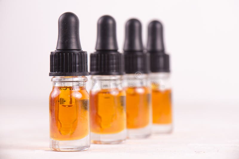 Vials of CBD oil, cannabis live resin extraction on whi stock photos