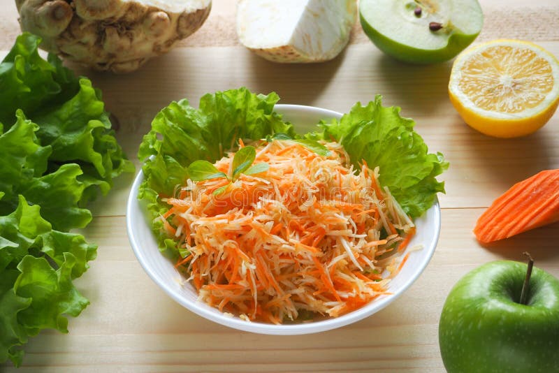 Vitamin salad with apple, carrot and celery root. Vitamin salad with apple, carrot and celery root royalty free stock photo