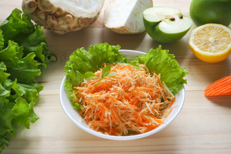 Vitamin salad with apple, carrot and celery root. Vitamin salad with apple, carrot and celery root royalty free stock photos