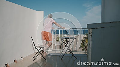 Man enjoys sea view from a hotel terrace on summer vacation stock video