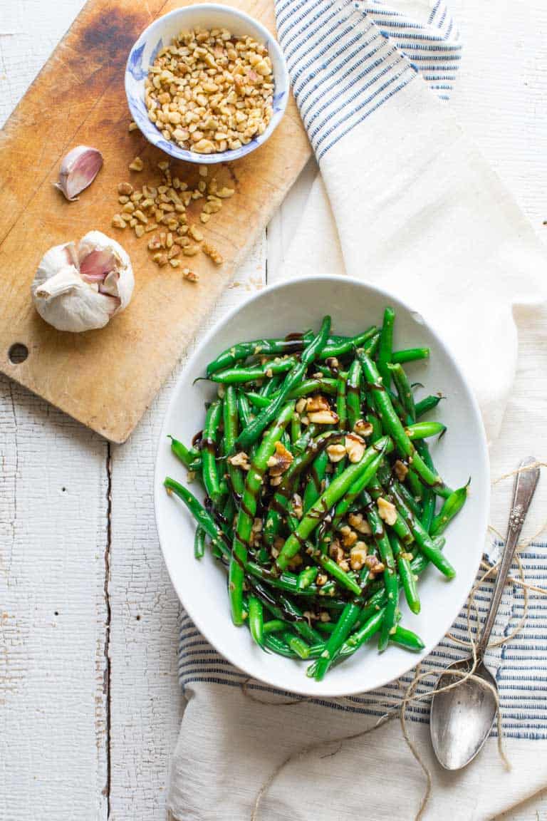 balsamic green beans with walnuts on towel