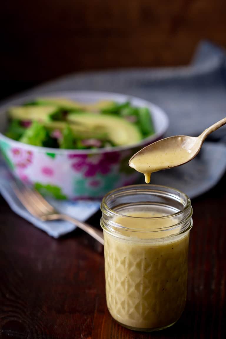 apple cider vinegar salad dressing in a jar with a spoon