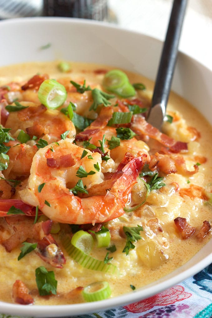 close up view of shrimp and grits in a bowl with a fork